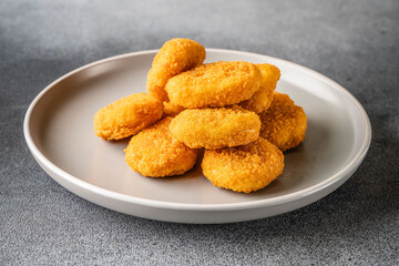 Crispy chicken nuggets on white plate