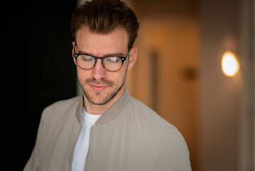 Headshot of a young man standing indoor