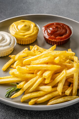 Close-up of french fries with sauces