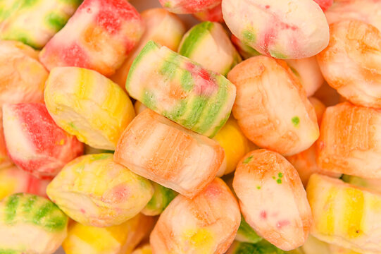 Sweet multi-colored sugar candies on a white background. Close-up.