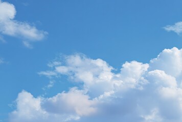 Azure sky with fluffy white clouds, some casting soft shadows, filling the frame with bright, airy, atmospheric openness
