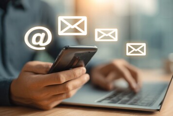 Person using a laptop and smartphone, with overlaid glowing mail icons, suggesting email communication and connectivity