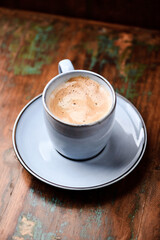 Cup of coffee on rustic wooden background. Soft focus. Copy space	