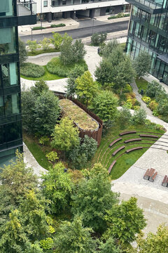 Eco city oasis: biophilic office district with pocket park, green-roof pavilion and amphitheater. Walkable, low-carbon space supports wellbeing, community, meetings and sustainable urban living eco