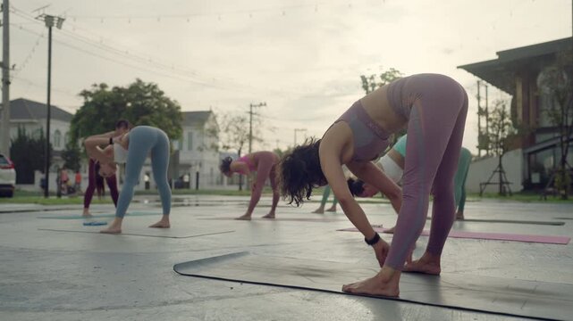 Mature women practicing yoga together outdoors, demonstrating flexibility, balance and the power of staying active through movement.