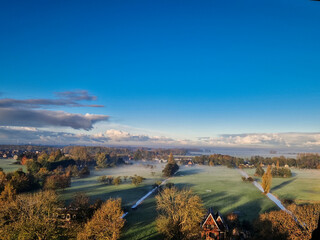Breathtaking balcony view overlooking the lush green fields of Holland's countryside during a misty summer sunrise near Amsterdam, Netherlands