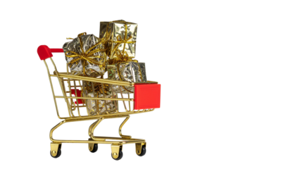 Shopping cart full of Christmas gifts and money in a retail market on white background