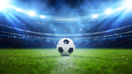 Naklejka premium Soccer ball on a vibrant green field under bright stadium lights during a thrilling night game.