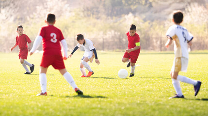 Kids soccer football - children players match on soccer field