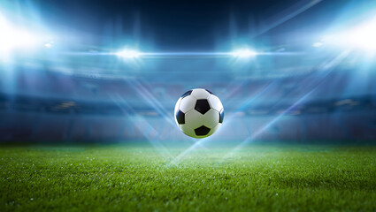 Dynamic soccer ball action in bright stadium lights over lush green field during game night
