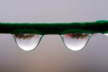 Close up of water drop on the rope reflecting cityscape, soft focus