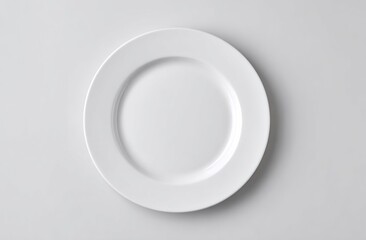 A simple, round, white, ceramic plate is centered against a plain, bright background, casting a slight shadow beneath