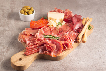 Charcuterie board. Antipasti appetizers of meat platter with salami, prosciutto crudo or jamon and olives.