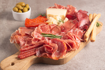 Charcuterie board. Antipasti appetizers of meat platter with salami, prosciutto crudo or jamon and olives.