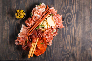 Charcuterie board. Antipasti appetizers of meat platter with salami, prosciutto crudo or jamon and...
