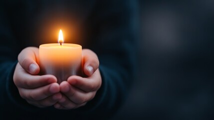 Childs hands hold a candle of hope.
