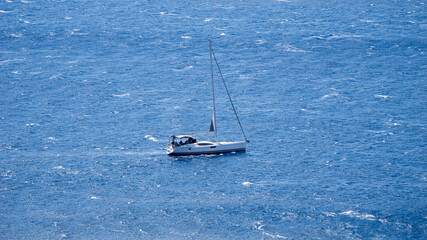 Obraz premium Sailing Yacht on Deep Blue Aegean Sea under Clear Sky – Summer Nautical Travel Concept