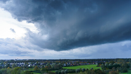 Fototapeta premium Breathtaking balcony view overlooking the lush green fields of Holland's countryside during a stormy summer sunset near Amsterdam, Netherlands