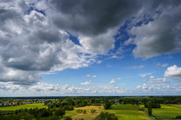 Breathtaking balcony view overlooking the lush green fields of Holland's countryside during a stormy summer sunset near Amsterdam, Netherlands