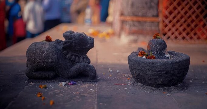 Stone idols of Shivalinga and Nandi surrounded by a devotional atmosphere, radiating deep spirituality and divine energy, reflecting the essence of Hindu culture and sacred traditions
