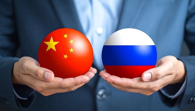 A person holding two spheres, one with the Chinese flag and the other with the Russian flag, symbolizing a relationship