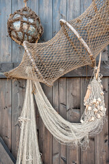 Decorative use of fyke net and fish net on a wooden wall in the archipelago of Gryt, Sweden