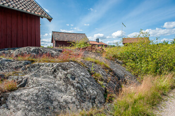 Summer in Sweden – traditional red little cottages at Harstena island in the Baltic Sea. This former fishing village in the Swedish archipelago of Gryt is now a popular tourist destination.