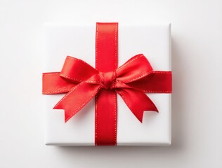 A white, square gift is wrapped with a vibrant red satin ribbon, tied in a classic bow, centered on a plain, neutral background