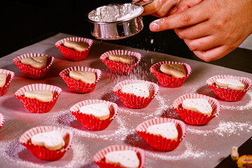 Hands preparing heart cookies