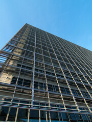 Abstract view of modern high-rise building with metal and glass facade.