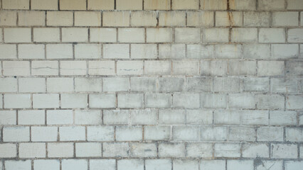 Old wall made of yellowish rectangular bricks