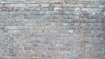 Old wall made of rectangular brown bricks