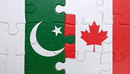 Jigsaw puzzle combining Pakistan and Canada flags on white surface, symbolizing diplomatic connection and unity.