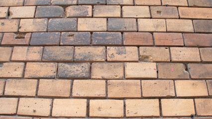 Old wall made of yellowish rectangular bricks