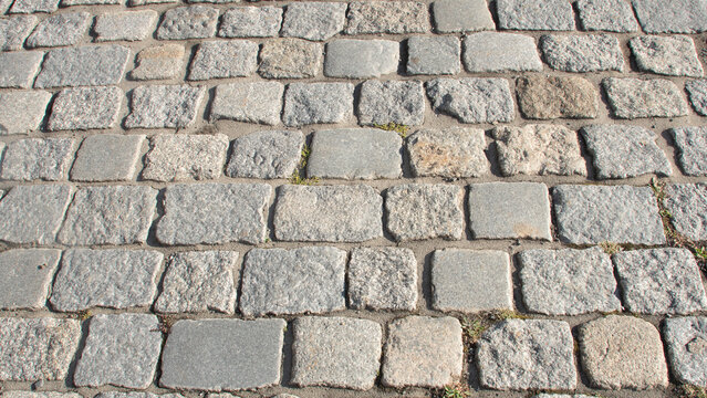 Fototapeta Texture of old flooring made of rectangular grey stone paving stones