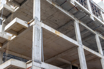 Partially constructed building with exposed concrete beams and columns