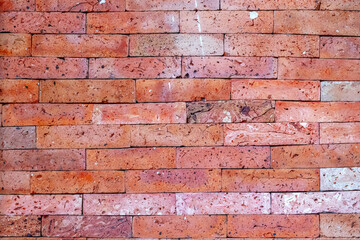 Red brick wall texture with varied patterns and natural aging