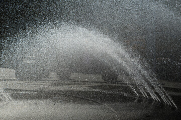 Jets of water at a public fountain freshing the central square of the down town