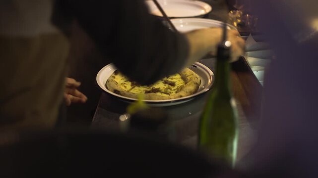 Wood-fired oven with sourdough pizzas in a restaurant at night in Buenos Aires, chefs cooking, warm lights and busy kitchen atmosphere.
