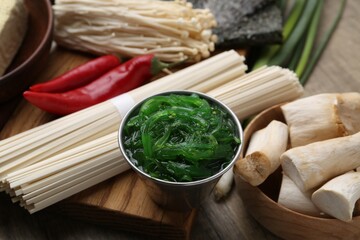 Enoki, king oyster (eryngii) mushrooms and other ingredients for ramen on table, closeup