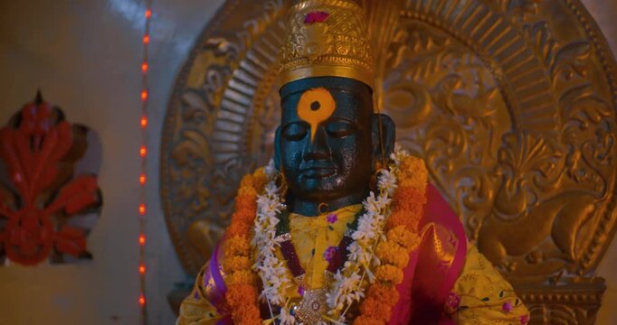 Sacred black stone idol of Lord Vitthal in the temple sanctum, radiating devotion and spirituality, symbolizing the essence of Hindu culture and divine faith