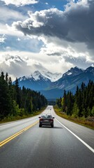 Fototapeta premium Point-of-view driving a car on a highway through a forest with mountains in the distance