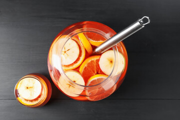 Fruity punch on black wooden table, flat lay. Refreshing drink