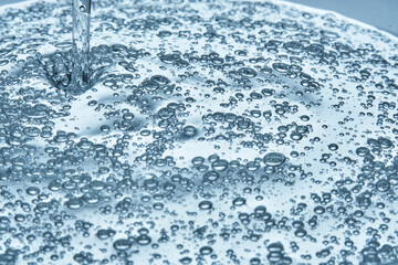 The texture of hyaluronic cleansing for the face or serum in blue tones.