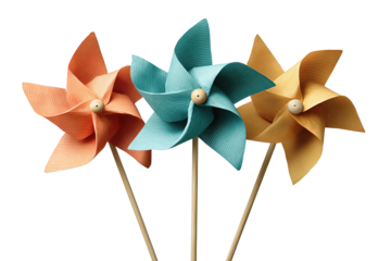Three colorful paper pinwheels in coral, teal, and mustard with wooden sticks crossing at the base, blades turned differently, isolated on transparent background.
