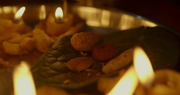 Decorative oil lamps in a Diwali puja thali and glowing diyas around the house, illuminating the home with festive light, devotion, and joy