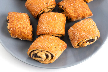 Poppy seed, sweet biscuits on plate, highlighted on white background.