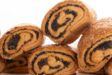 Biscuits with poppy seeds on white background closeup.