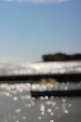 A blurry background view of the pier and sea