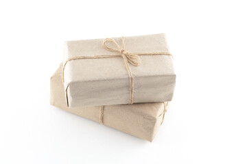 Two brown boxes with a string tied to them. The boxes are on top of each other